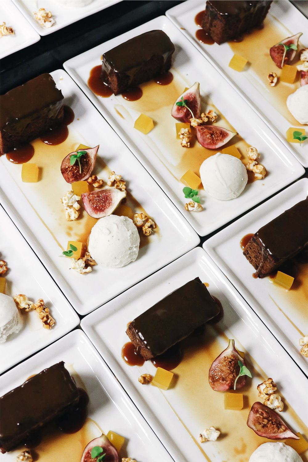 Plates with ice cream near figs and chocolate cakes · Free Stock Photo
