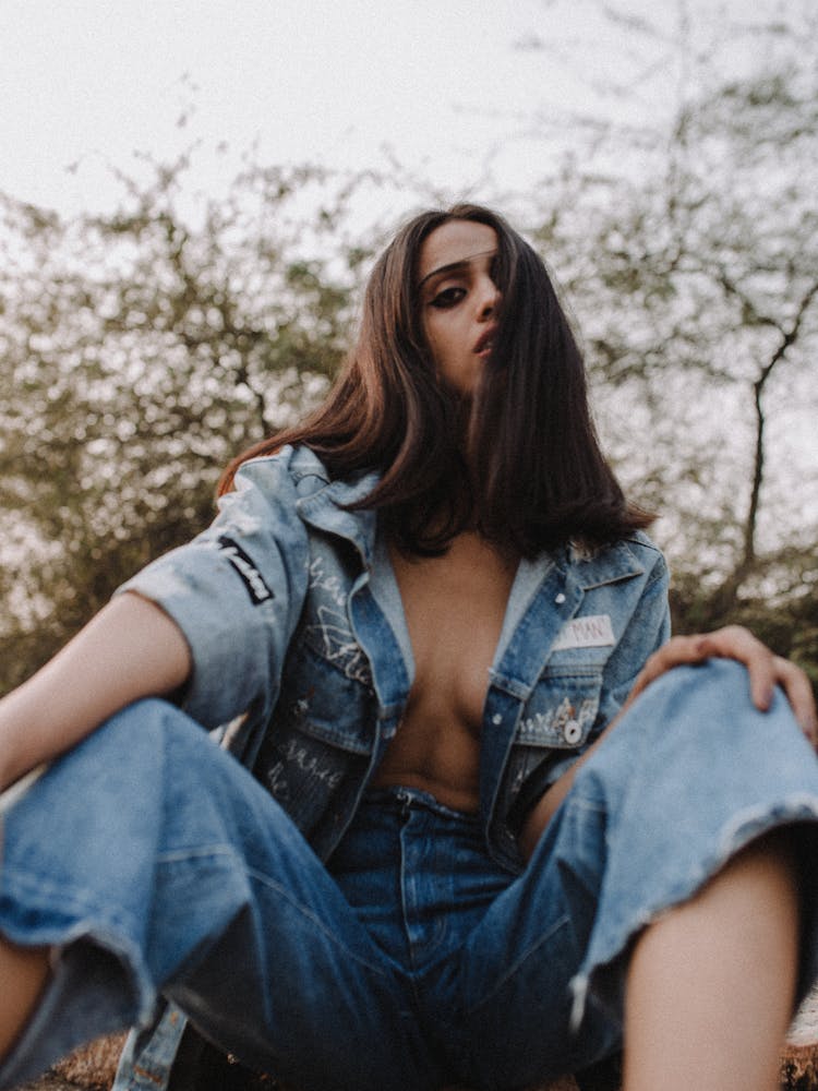 Woman On Ground Near Plants And Trees