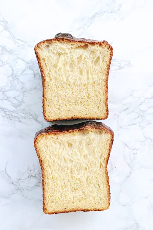 Free Top view of delicious homemade bread placed on white counter in light place Stock Photo