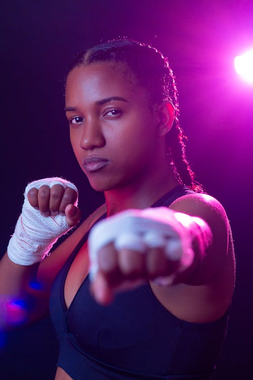 Boxer Woman Wearing Sports Bra and Boxing Gloves Stock Photo