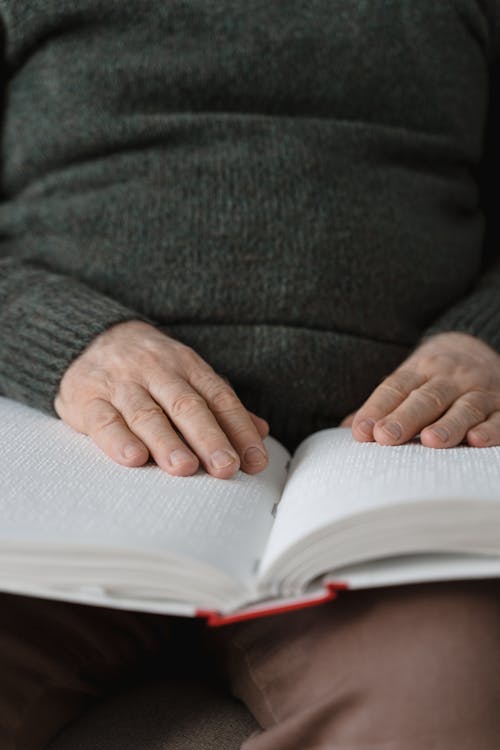 Free A Person Reading a Braille Book Stock Photo