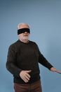 Blindfolded Elderly Man in Gray Long Sleeve Sweater