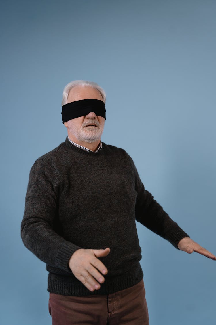 Blindfolded Elderly Man In Gray Long Sleeve Sweater