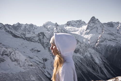 Free a Person Looking the Snow Mountains Stock Photo