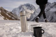 Black Ceramic Mug on White Snow