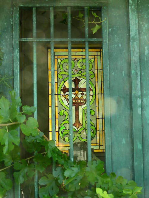 Green Photo of a Stained Glass with Cross Behind a Door