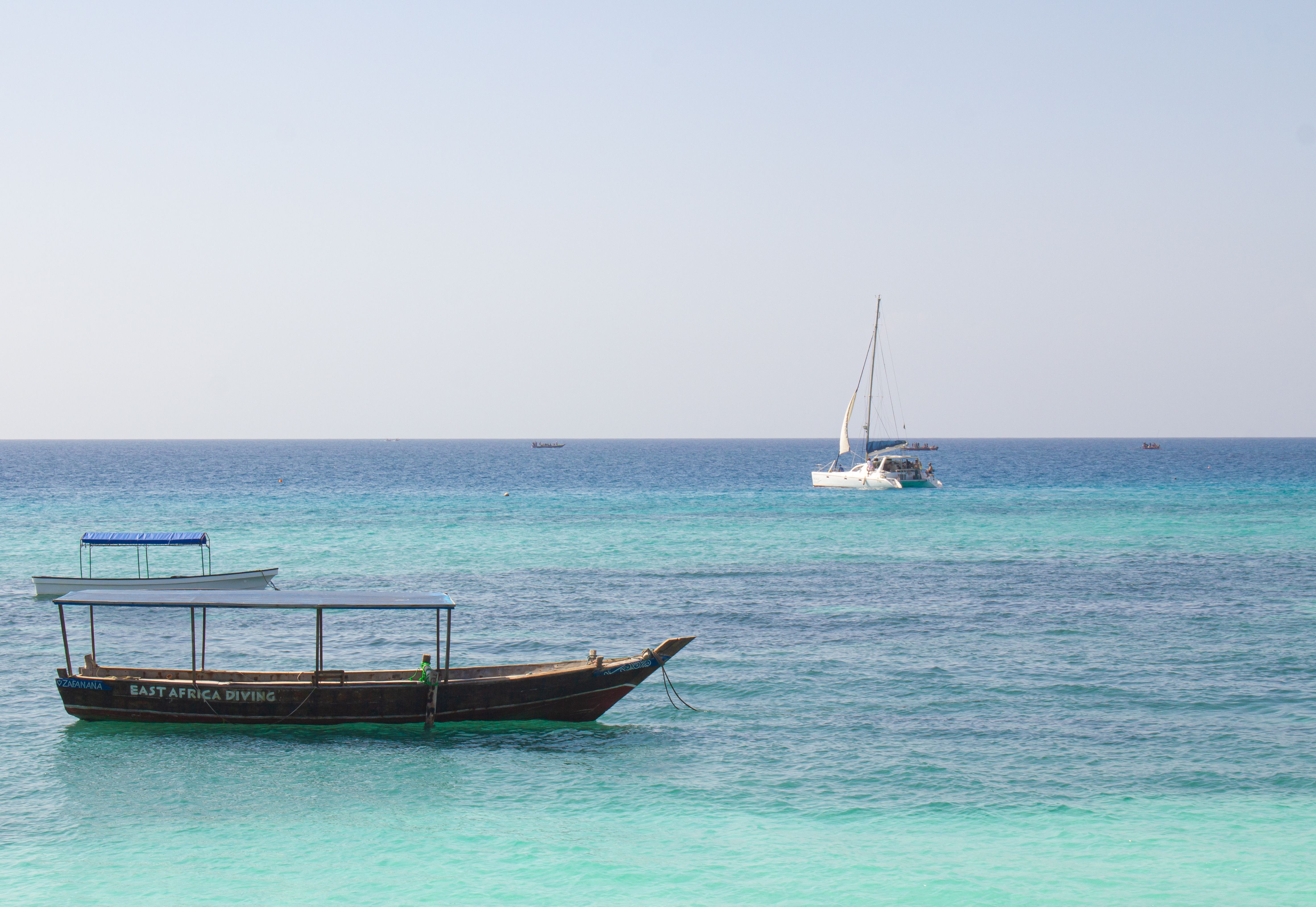 Peaceful seascape featuring sailboats on turquoise waters of Zanzibar, Tanzania.
