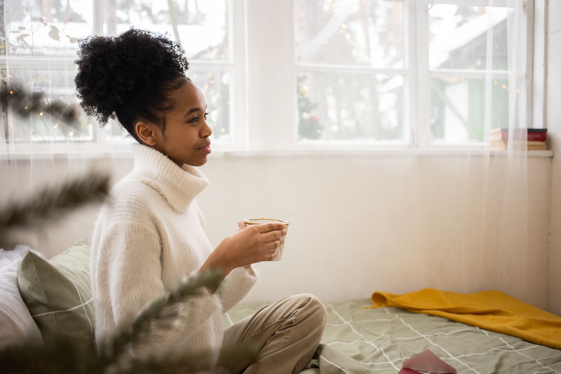 ADHD revenge bedtime procrastination sleep executive dysfunction — person cozy pajamas holding tea soft bedroom lamp warm