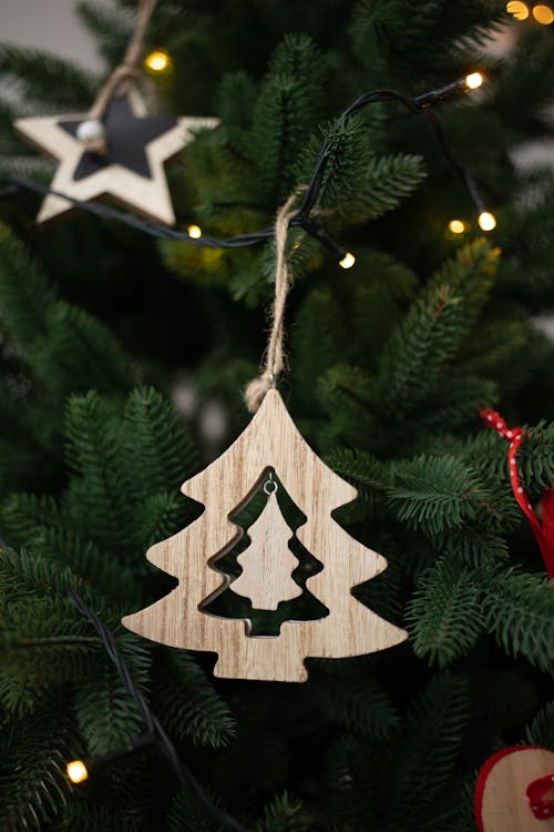 A Wooden Pine Tree Christmas Ornament Hanging on a Christmas Tree