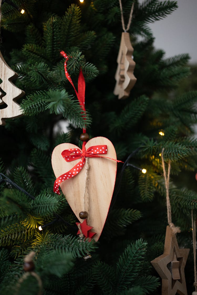 Wooden Christmas Ornaments Hanging On A Christmas Tree