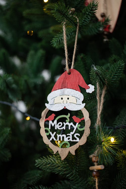 A Santa Claus Christmas Ornament Hanging on Christmas Tree