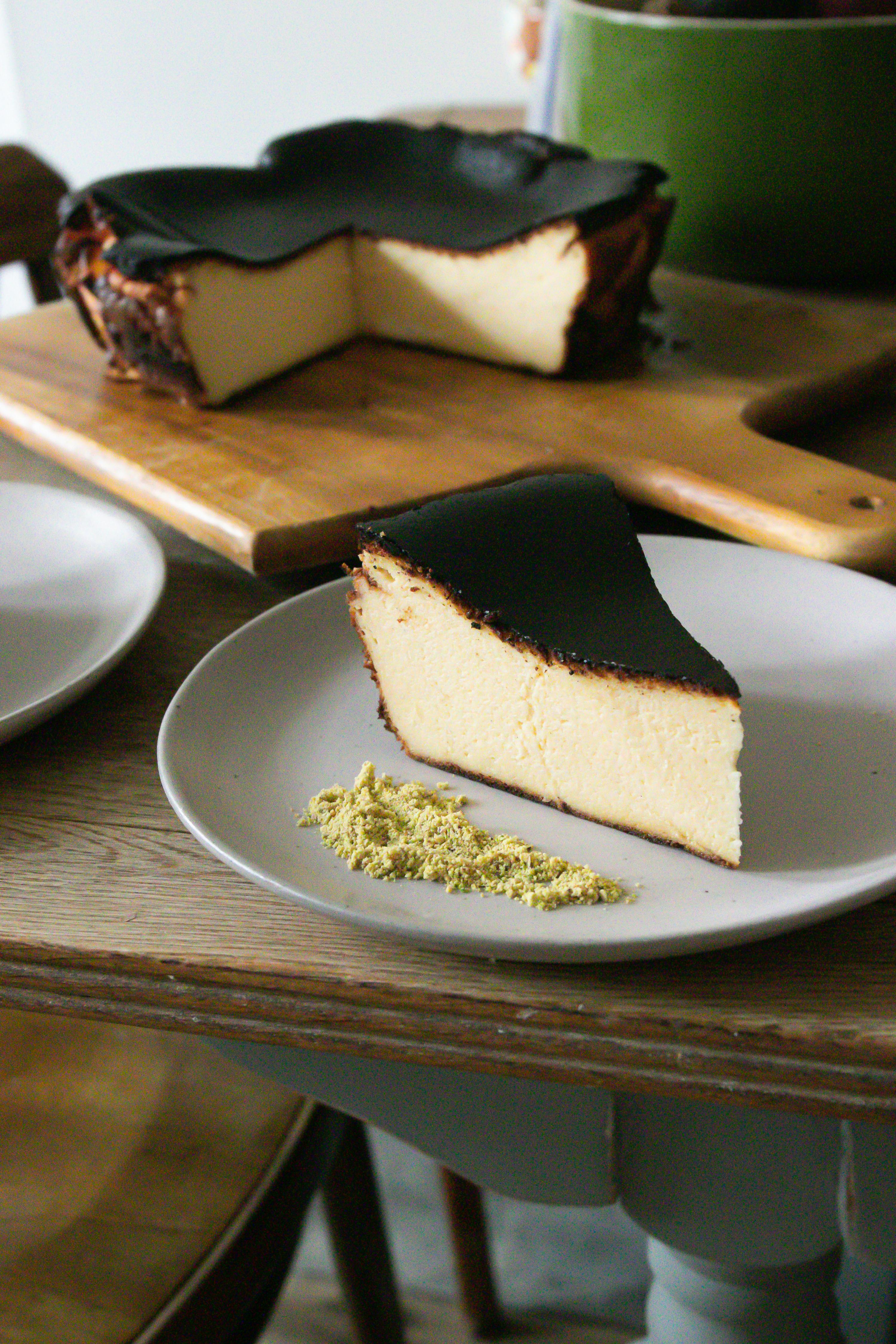 basque burnt cheesecake on plate and cutting board on table