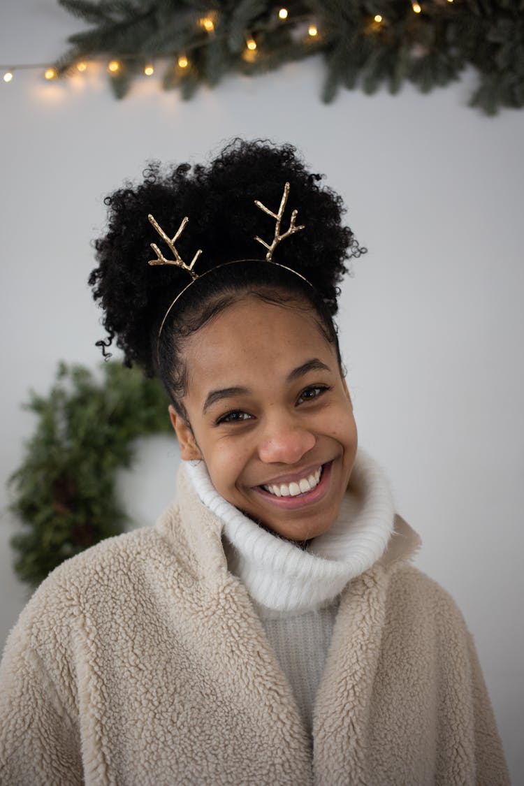 A Young Woman Wearing A Reindeer Headband