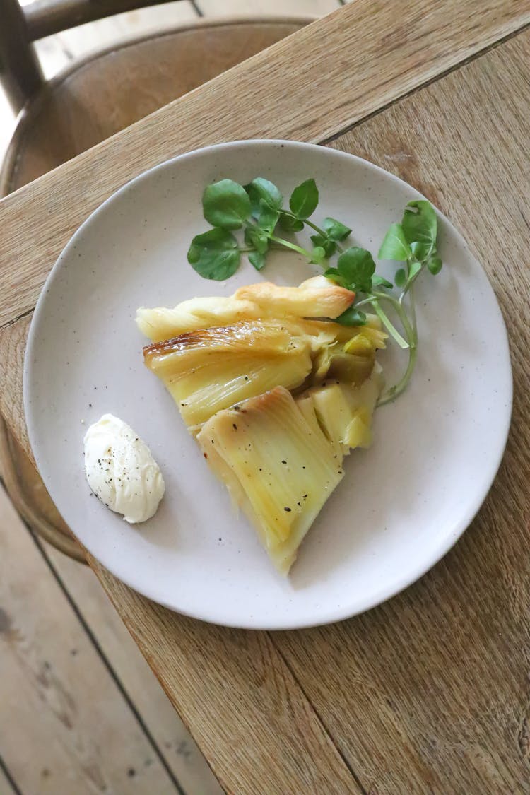 Rhubarb Pie With Herb And White Cream On Plate