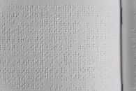 A Close-up Photo of Braille Characters in a White Paper
