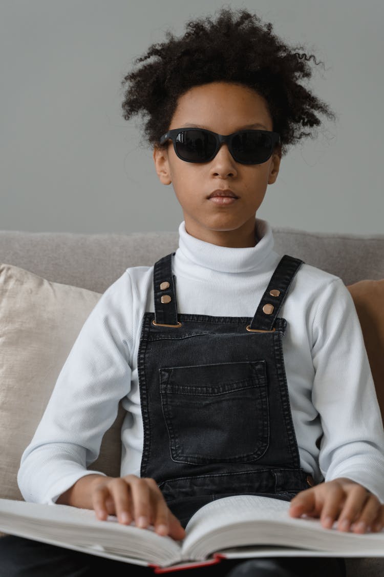 A Young Child Reading By Braille Method