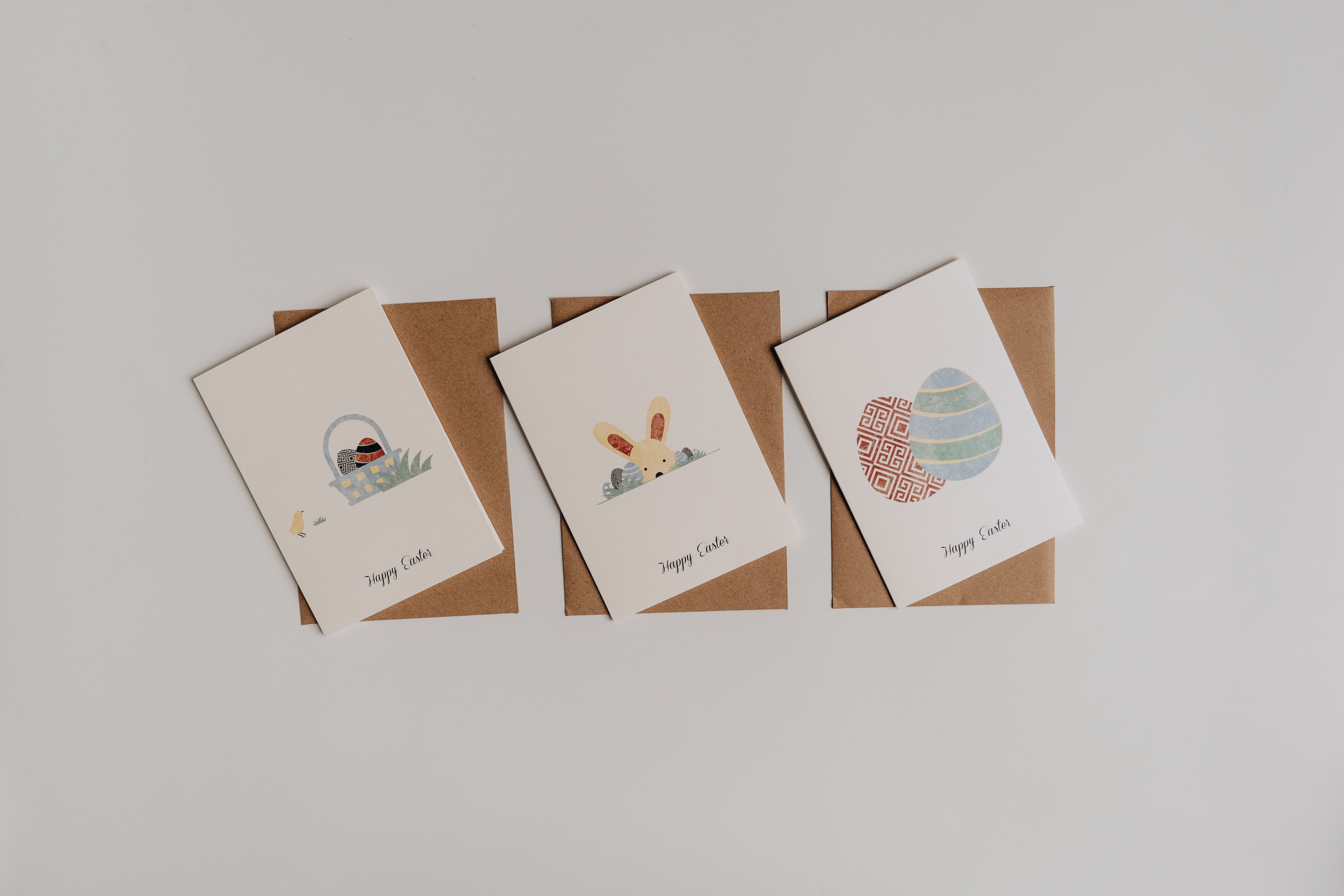 Four delightful Easter greeting cards with envelopes on a white background.