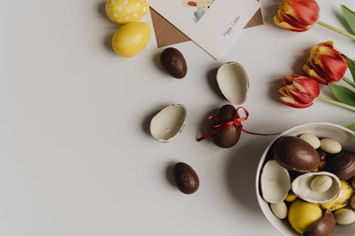 Delicious Easter Egg Chocolates on a Surface with Tulip Flowers