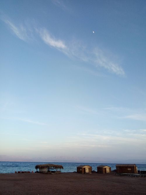 Free Peaceful seaside view of beach huts with a sunrise sky in South Sinai, Egypt. Stock Photo
