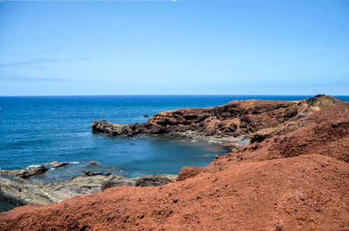 Free Explore the stunning volcanic coastline of Lanzarote with its striking rock formations and clear blue sea. Stock Photo