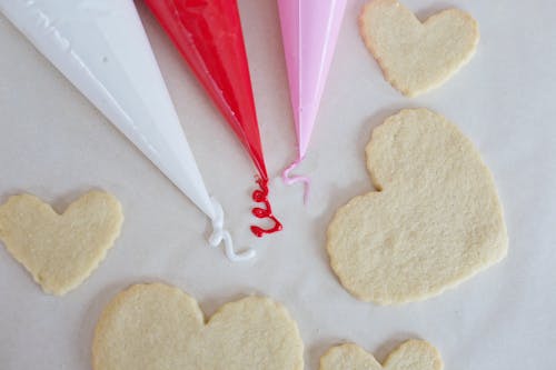 Piping Bags Beside Heart Shaped Cookies