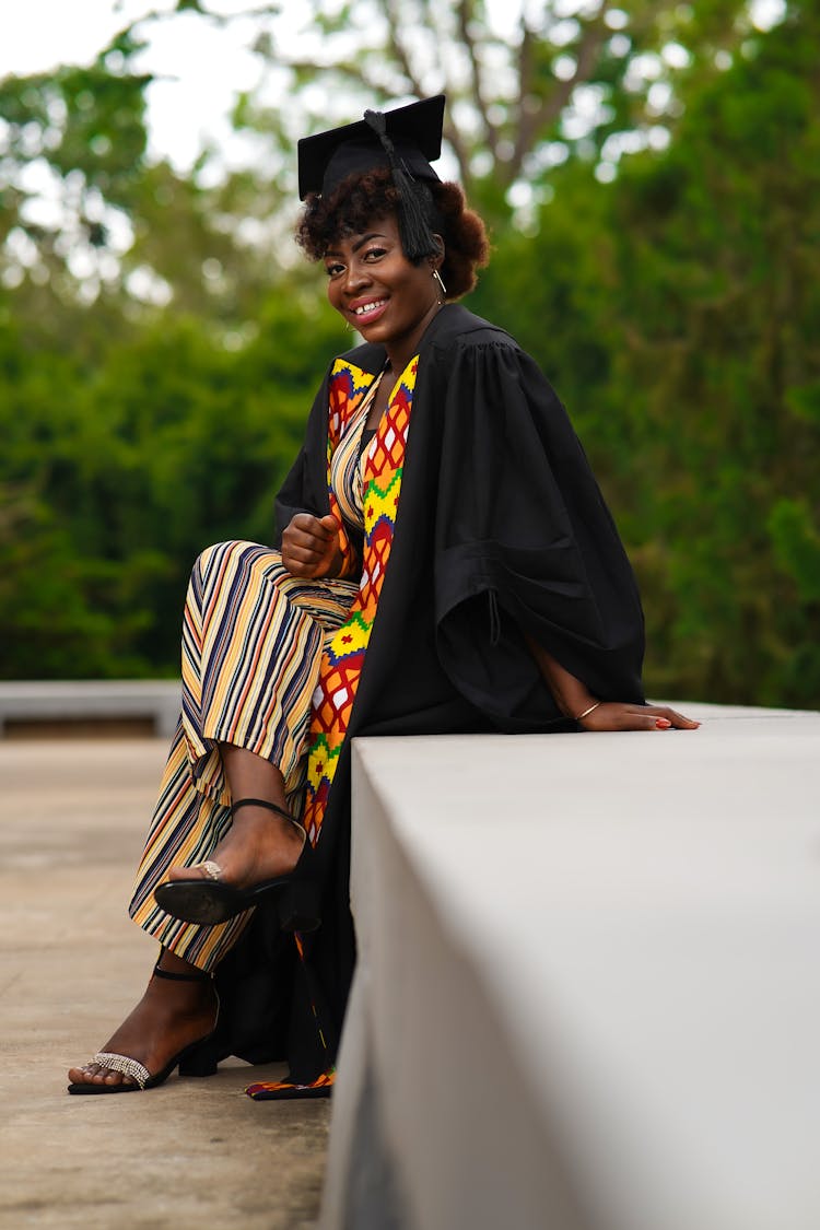 Smiling Woman In Graduation Mantle And Cap