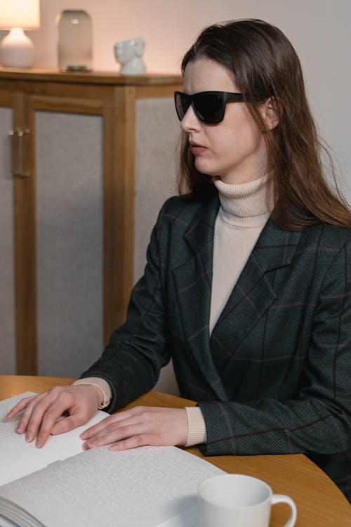 A Blind Woman Reading a Braille Book