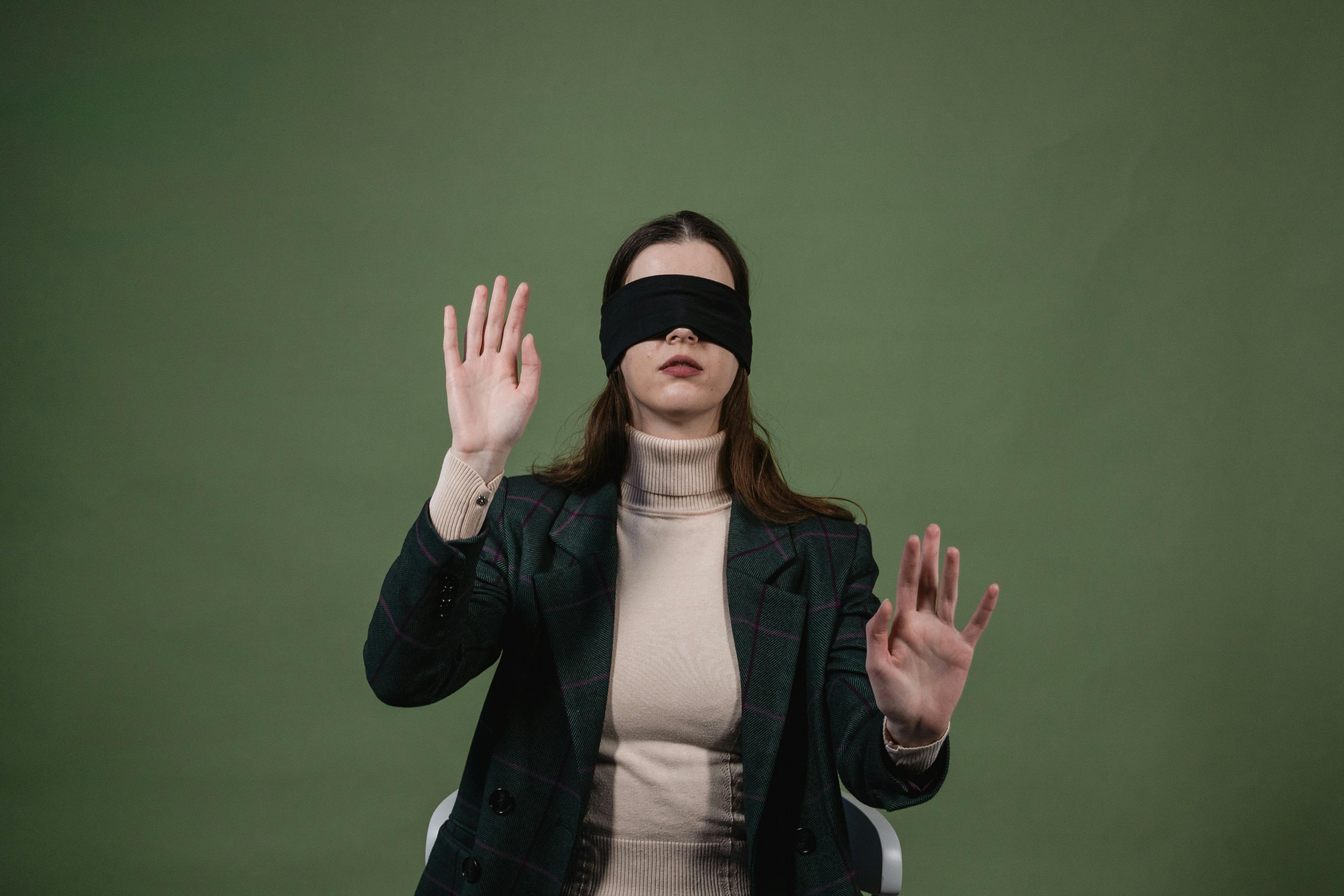 Woman blindfolded, smiling - Stock Image - F003/3209 - Science Photo Library