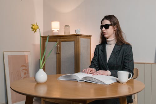 A Blind Woman Reading a Braille Book