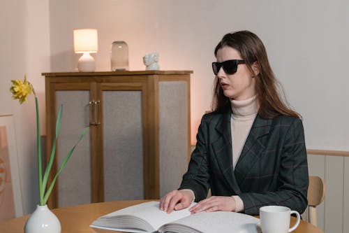 A Blind Woman Reading a Braille Book