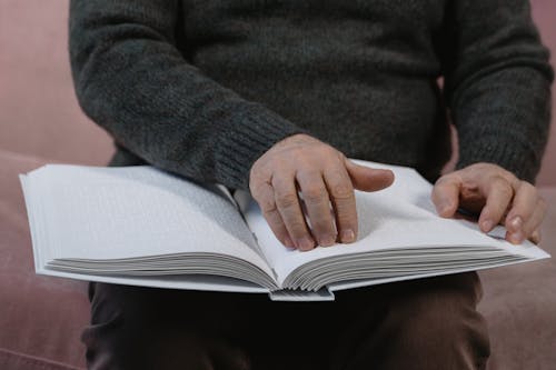 Free A Blind Person Reading a Braille Book Stock Photo