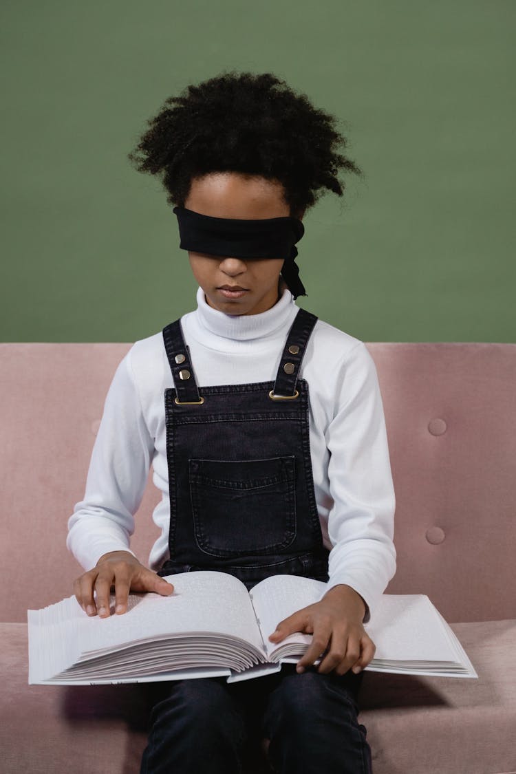 Blindfolded Girl Reading A Braille Book