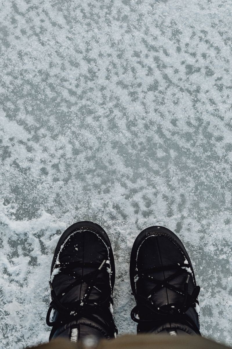 Black winter boots on snowy surface