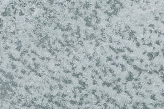 Close-up view of a snow-covered surface from above, showcasing winter texture.