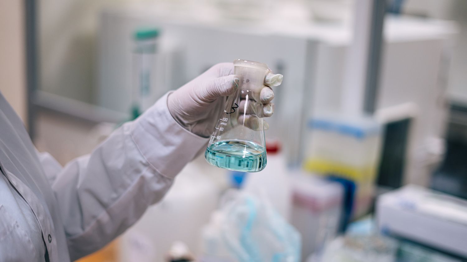Scientist examining a liquid sample in a laboratory