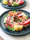 Fresh salad with healthy vegetables on plates on table