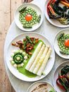 White asparagus with sauce near vegetarian dishes with herbs