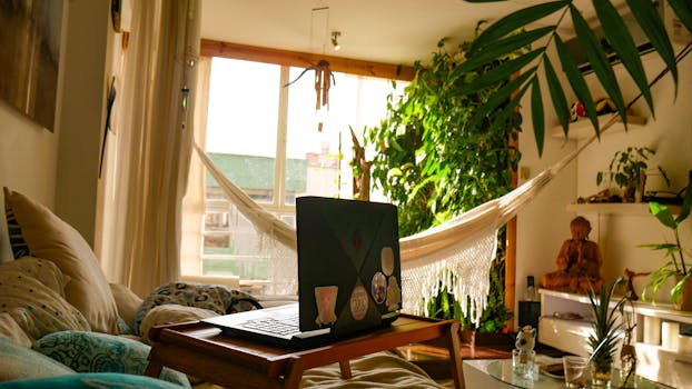 Inviting home workspace with a hammock, laptop, and abundant greenery, creating a relaxing atmosphere.