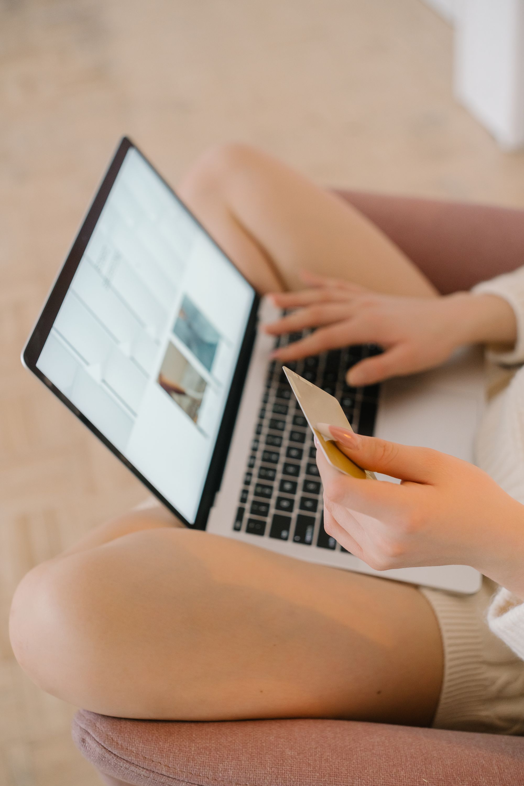Person using a laptop and credit card for financial transactions