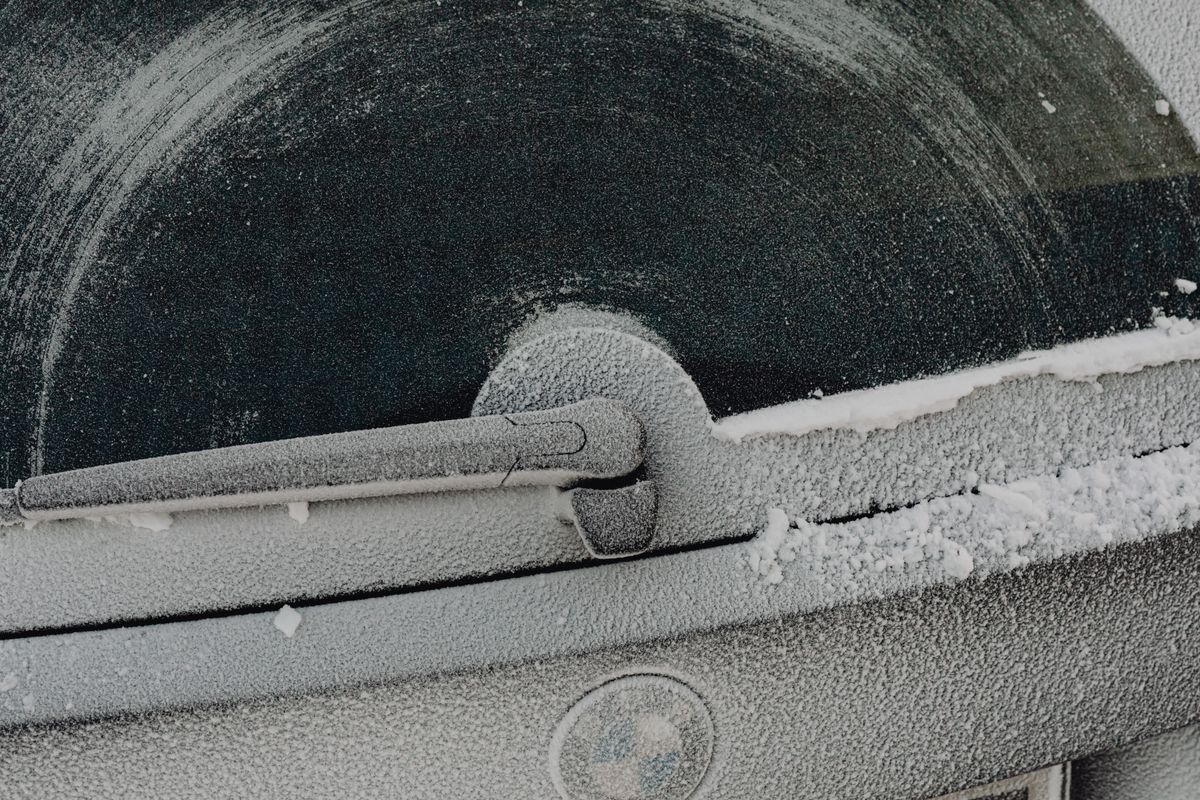 Frost-covered rear window wiper on an SUV during a cold winter morning (Photo via Pexels)