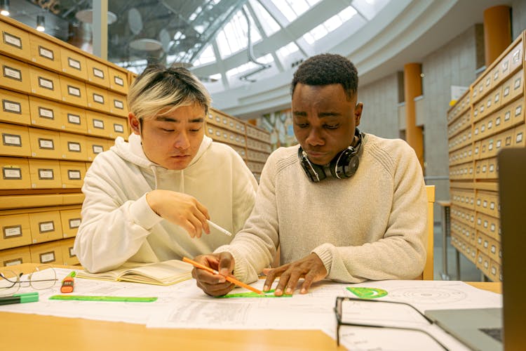 Students Drawing On The Table