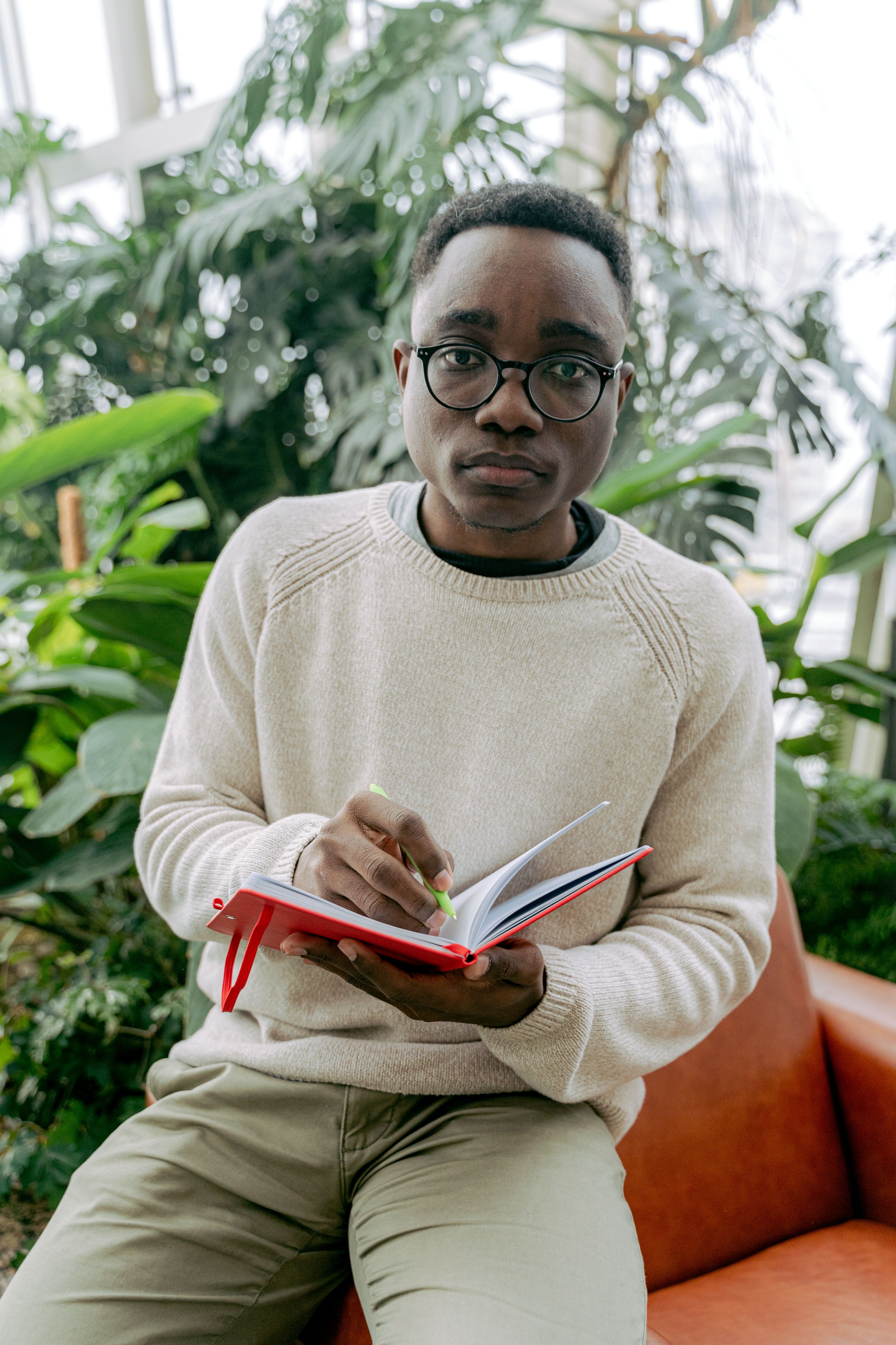 Portrait of a calm facilitator holding a notebook