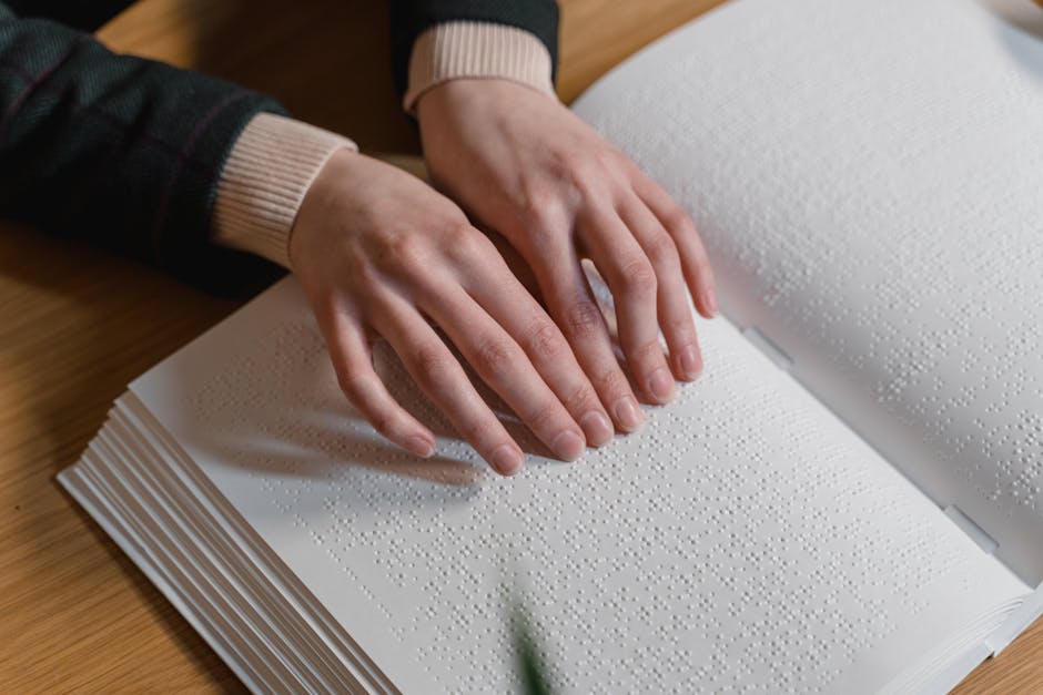 Close-up of hands reading Braille, symbolizing independence and accessibility for the visually impaired.