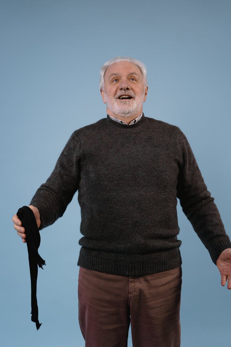 An Elderly Man Wearing A Sweater