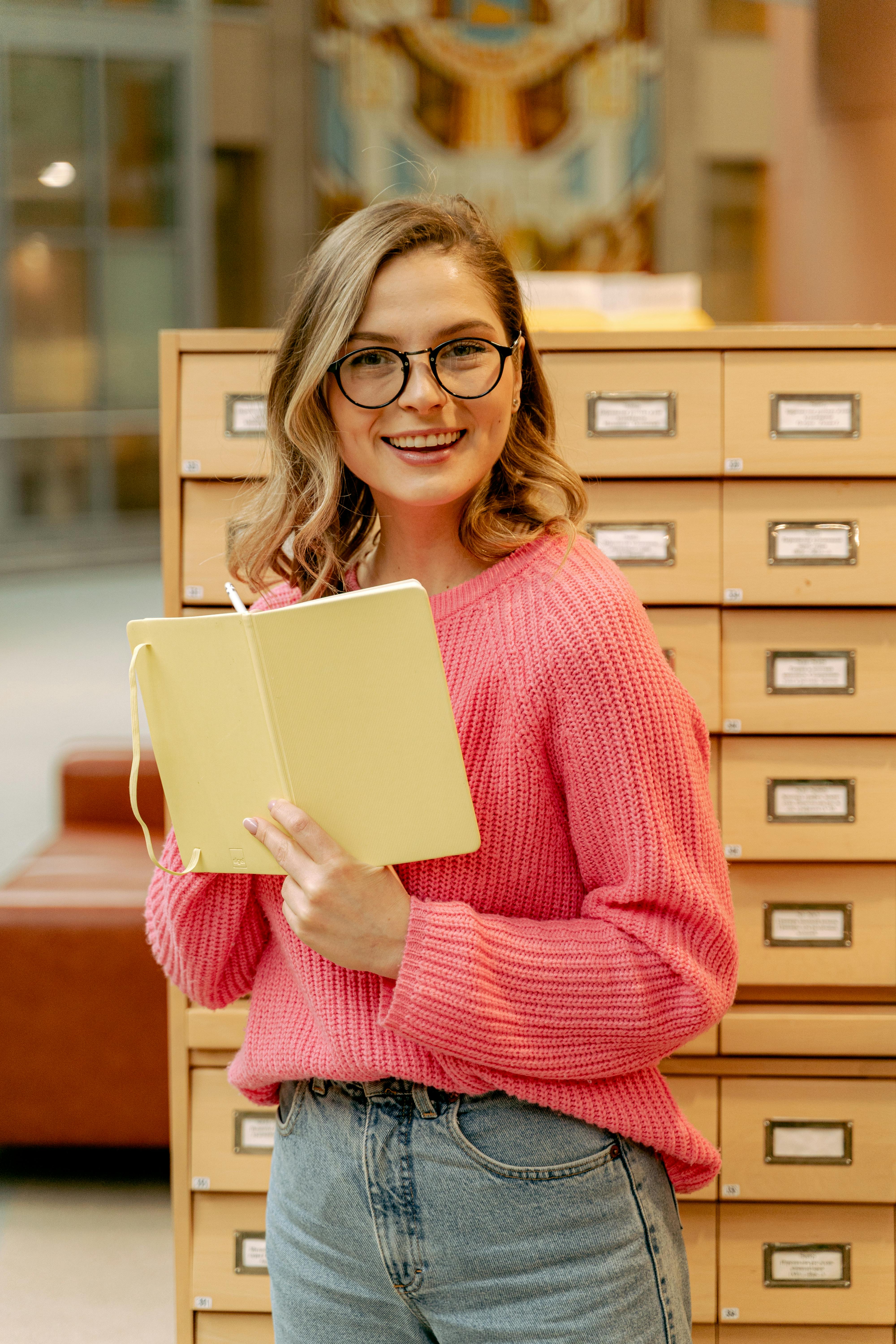 Smiling Blonde Woman With Notebook · Free Stock Photo