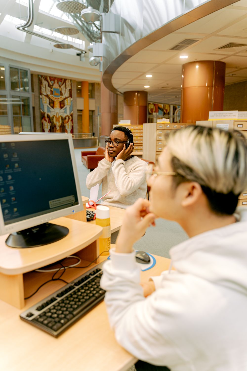 Two people at a library computer