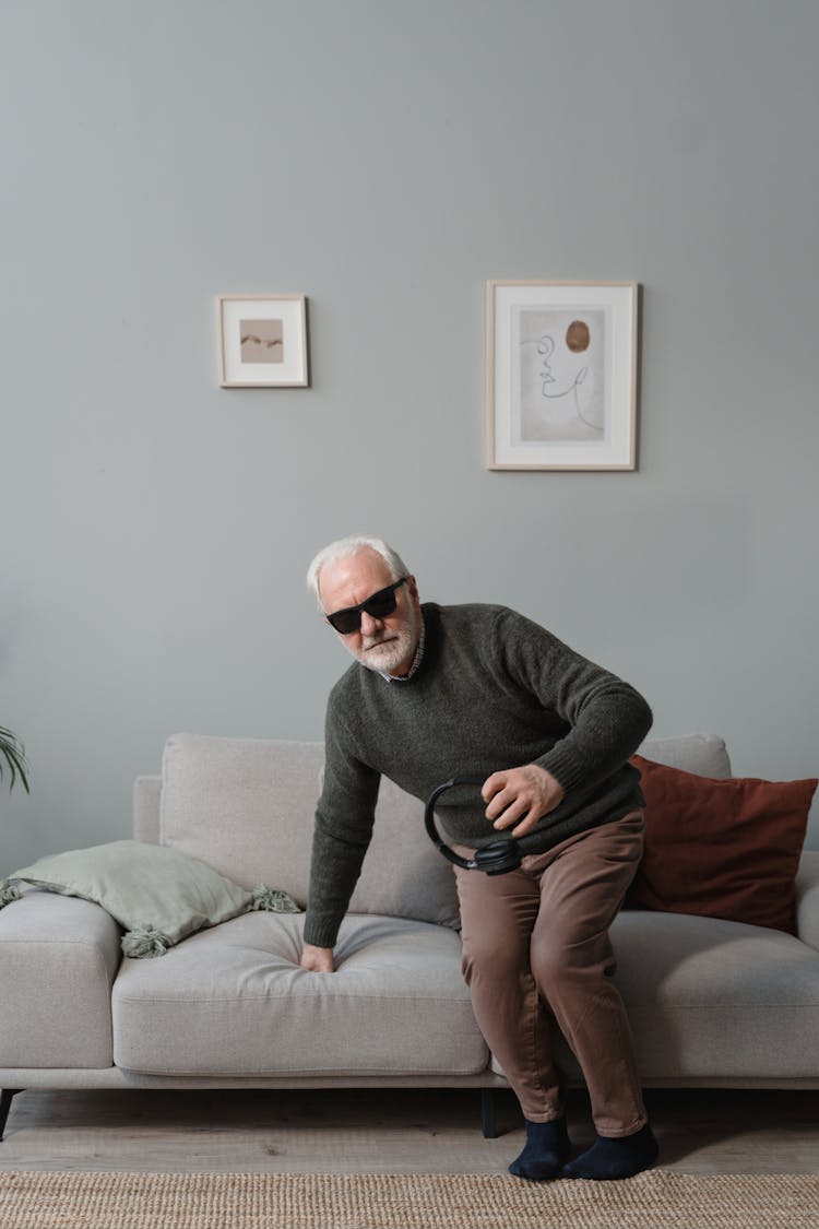 Blind Man Sitting Down On Sofa