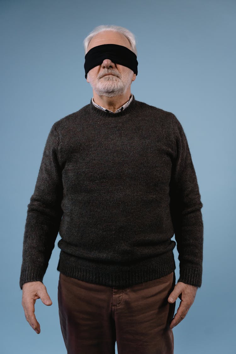 Elderly Man In Black Sweater With Black Fabric On Covered Eyes