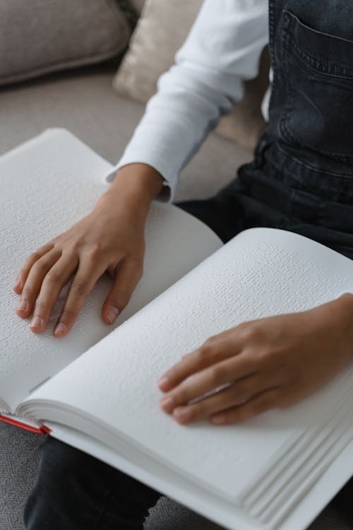 A Person Touching a Braille Book