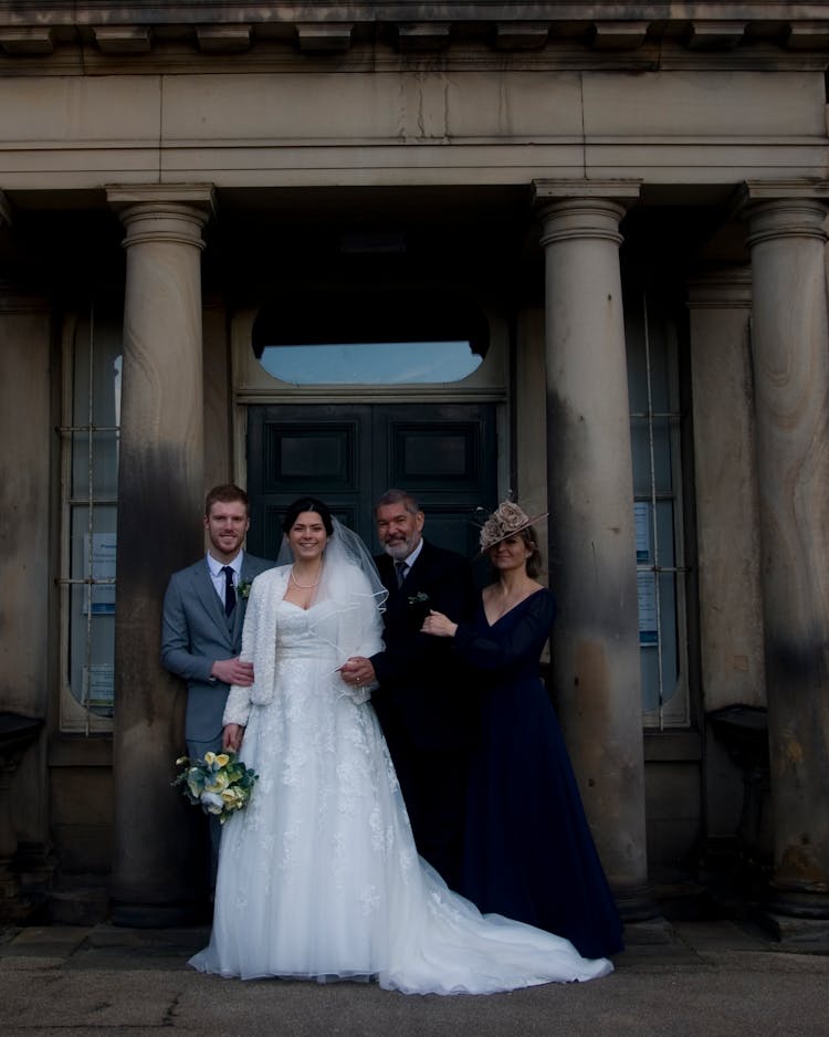 A Bride And Groom With Parents